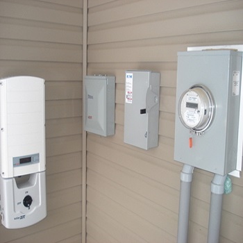 Solar inverter and electrical disconnect mounted outdoors.