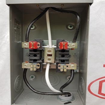Main electrical service disconnect with large gauge wires connected.