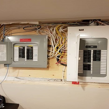 Dual electrical panels with organized wiring installation.