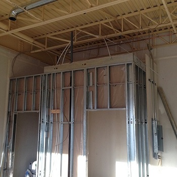 Metal wall framing with electrical rough-in wiring.